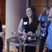 Three alumni enjoy conversation with one another